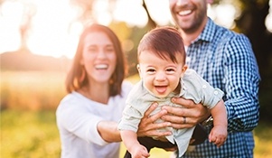 Laughing mother father and child outdoors