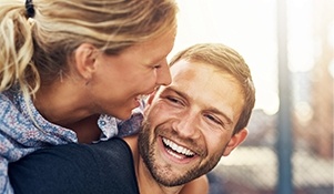 Smiling man and woman outdoors