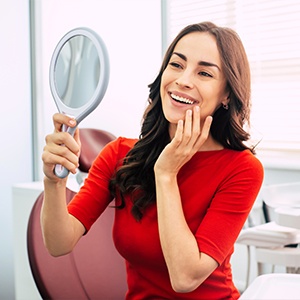 Woman looking at smile in mirror