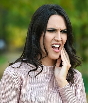 Woman holding jaw