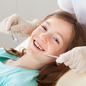 Smiling young girl in dental chair