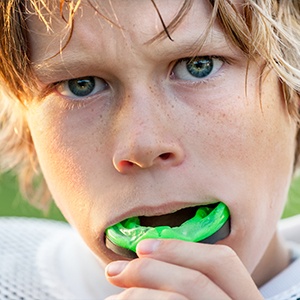 Teen placing mouthguard