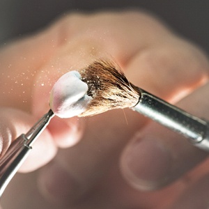 dentist brushing off a crown