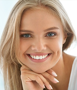 A beautiful young lady with blue eyes smiling.