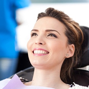 A woman sitting in the dentist chair smiling.