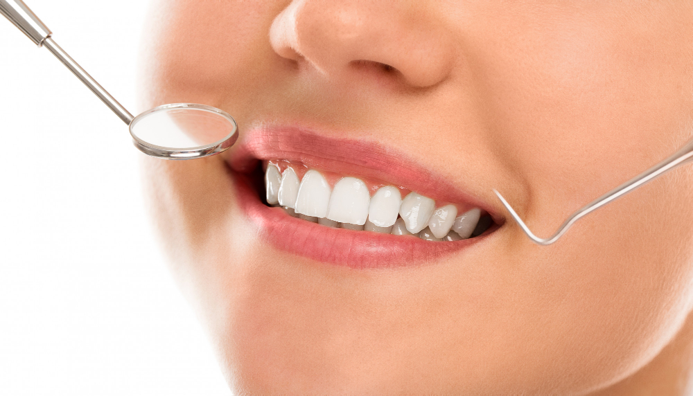 A man and woman are getting their teeth cleaned.