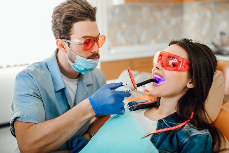 A man and woman are getting their teeth cleaned.